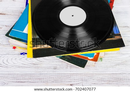 Pile of old vinyl records on wooden background