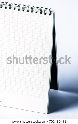 Isolated notebook with spiral on the grey-blue background