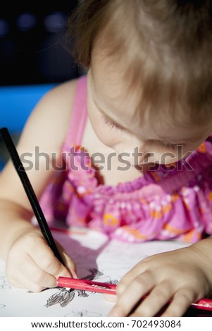 Great artist. Child girl drawing using colored pencils. Art, creative, talent concept.