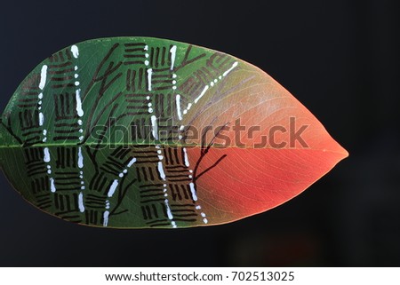 bamboo painting on green leaf on red light and black background