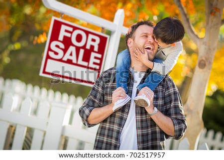 Young Mixed Race Chinese and Caucasian Father and Son In Front of For Sale Real Estate Sign and Fall Yard.