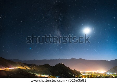 Milkyway and the moon on a city