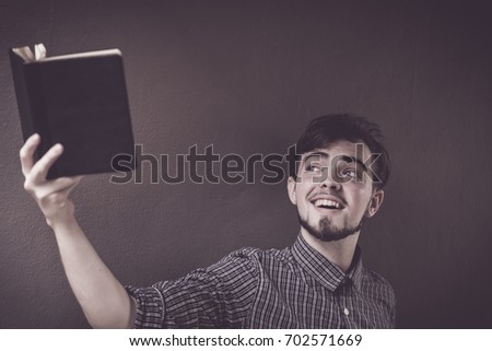Closeup on a man holding a bible at shopping mall, believe concept