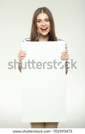 Smiling woman with long hair holding advertising sign board. Isolated portrait on white.