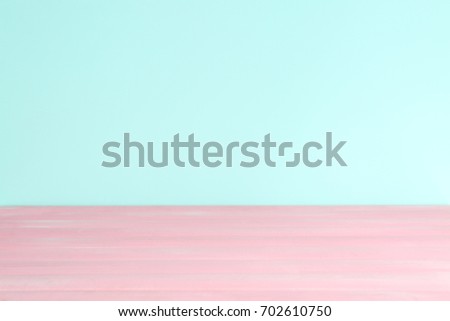 Wooden table against mint color background