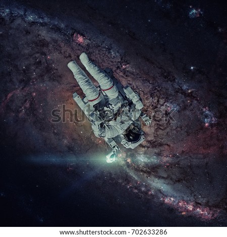 Astronaut in outer space. Nebula on the background. Elements of this image furnished by NASA. 