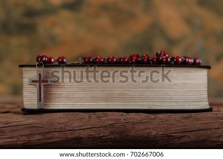 Bible and a crucifix on an old oak table. Beautiful background.Religion concept.