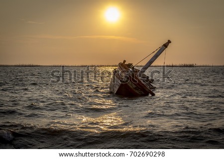 Boat crashes in the sea,Thailand. / An old shipwreck on beach. / Shipwreck in Ang Sila, Chonburi, Thailand. / Shipwreck in Thailand with sunset. Royalty-Free Stock Photo #702690298