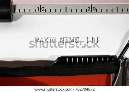 An Image of " fake news " written on a typewriter - Close up