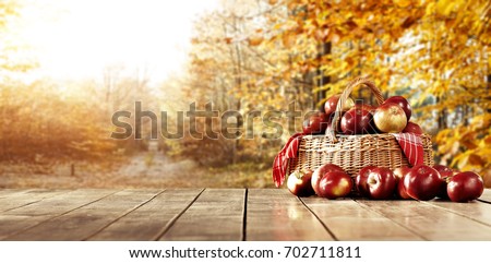 Wooden table in the kitchen with fresh apples in a wicker basket