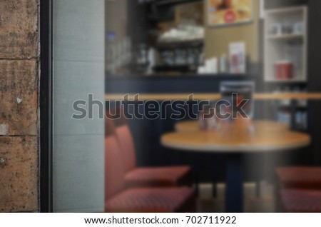 Coffee shop glass door mockup. Empty space on window for add logo Royalty-Free Stock Photo #702711922