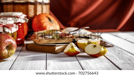 Juicy apples in a basket on a white wooden table in the morning sunlight