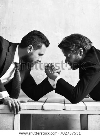 Managers. Challenge concept. Arm wrestling between employees of company in office.