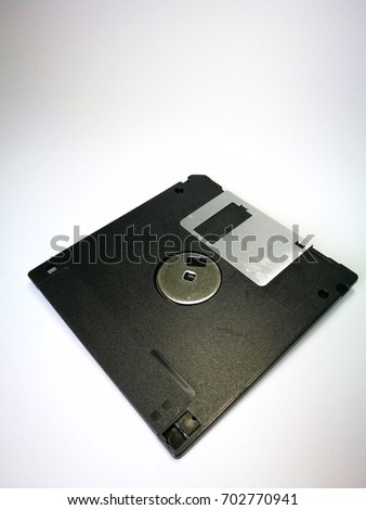 Black floppy disk on the back side , isolated on the white background