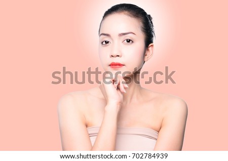 beautiful woman face. beauty portrait. beautiful spa woman touching her face. perfect fresh skin. pure beauty model girl. isolated on beige background.