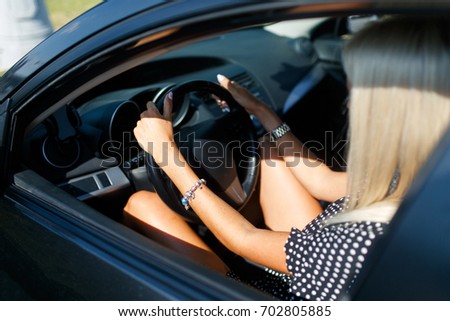 Photo from back of blonde driving car