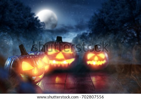 Scary pumpkin in a dark smoky garden on Halloween night