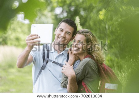 Hikers making pictures of themselves with a tablet