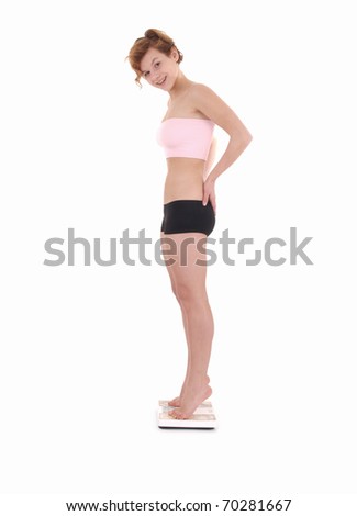 Pretty young woman on scale, isolated on white background