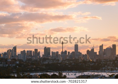 Sydney skyline under a warm sunset light.