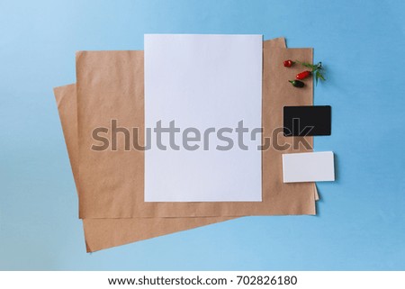 Kraft paper and a business card mockup. Cover brochure. Red pepper in a glass jar