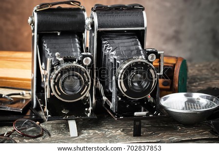 Color photo of an old cameras. Retro still