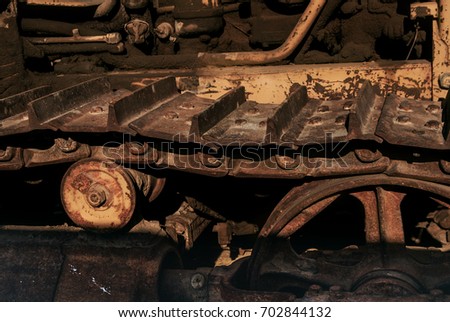 Closeup and Selective Focus Rusty Wheel of Earth Mover Track. 