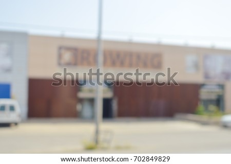 Blurred defocused image of commercial building, shopping street on sunny outdoors background