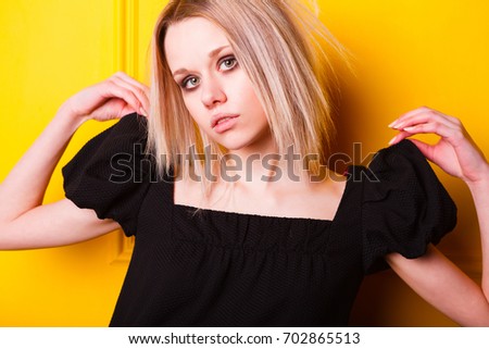Portrait of pretty lean girl on yellow background