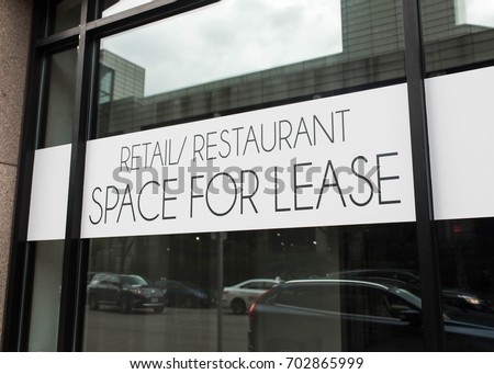 Retail/Restaurant Space for Lease Sign in urban environment. Commercial property in major city.