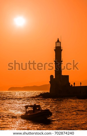 Picture of lighthouse sihoulette in the sunset.