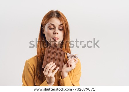 Woman eating chocolate, chocolate bar