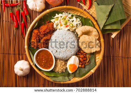 Nasi kerabu, popular Malay rice dish. Blue color of rice resulting from the petals of butterfly-pea flowers. Traditional Malaysian food, Asian cuisine. Royalty-Free Stock Photo #702888814