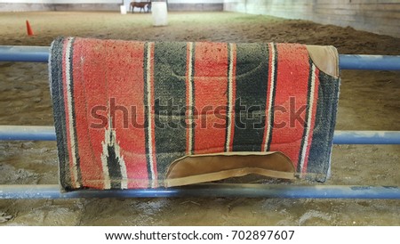 Old horse blanket on a get into a riding school