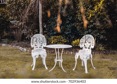 White table and chairs in the garden