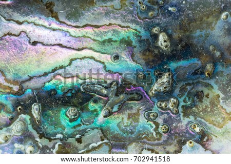 Nature texture pattern of nacre mother-of-pearl inner side of Paua, Perlemoen or Abalone shell macro abstract background Royalty-Free Stock Photo #702941518