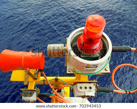 Manual fire alarm call point on offshore oil and gas platform.