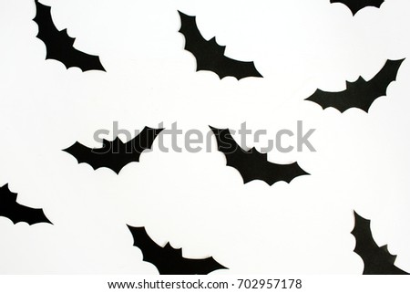 Halloween holiday concept. Handmade black paper bats on white background. Flat lay, top view.