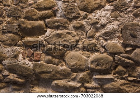 Stone wall background and ancient tuff, Tuscany in Italy