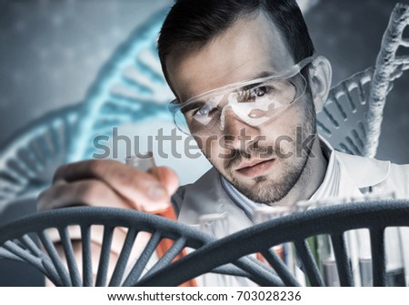 Handsome scientist making research over dna molecule structure