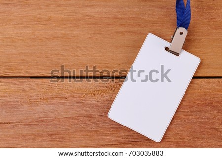 Blank Identification Card with Neckband on Wooden Background. Top View of Badge id or Name tag.