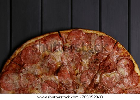 Hot pepperoni pizza on a wooden table
