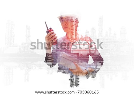 Asian engineer monitoring in oil and gas refinery plant, Double exposure engineering hand holding portable radio and process flow diagram for control in petrochemical industry Royalty-Free Stock Photo #703060165