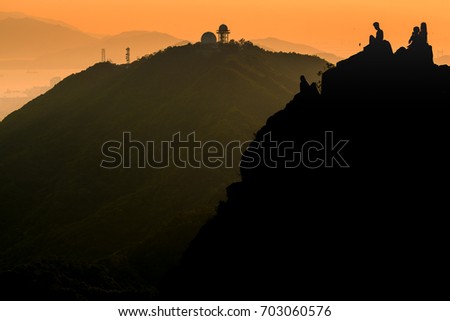 A man taking photo of Hong Kong city from the hill