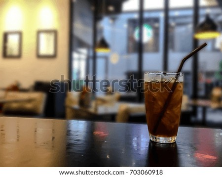 Glass of lemon tea on table with blurred restaurant background. Ice tea on table in restaurant. Lemon ice tea on table with copy space for text.