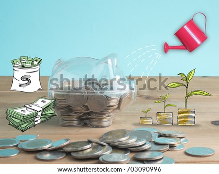 transparent see through piggy bank filled with coins on wood background.