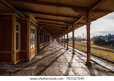 Old train station. Wooden wrok from last century, vintage style of Northern Europe. Royalty-Free Stock Photo #703167340