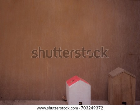 vintage miniature wooden house model/toy with wooden background. home purchase mortgage concept