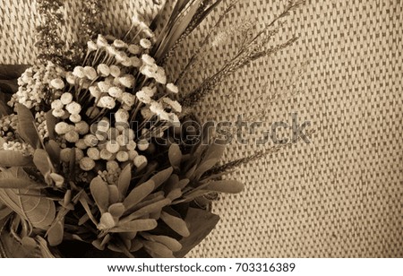 Cute background with a bouquet of meadow flowers. Warm atmosphere of coziness, autumn abundance, good mood. Tinted image, there is a blur, grain effect.