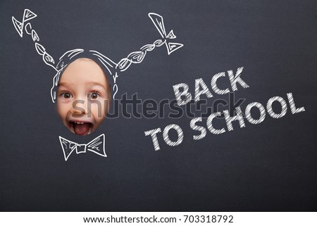 Pretty small girl with cartoon plaits and sign Back to School against the black background. Photo face stand-in cutout